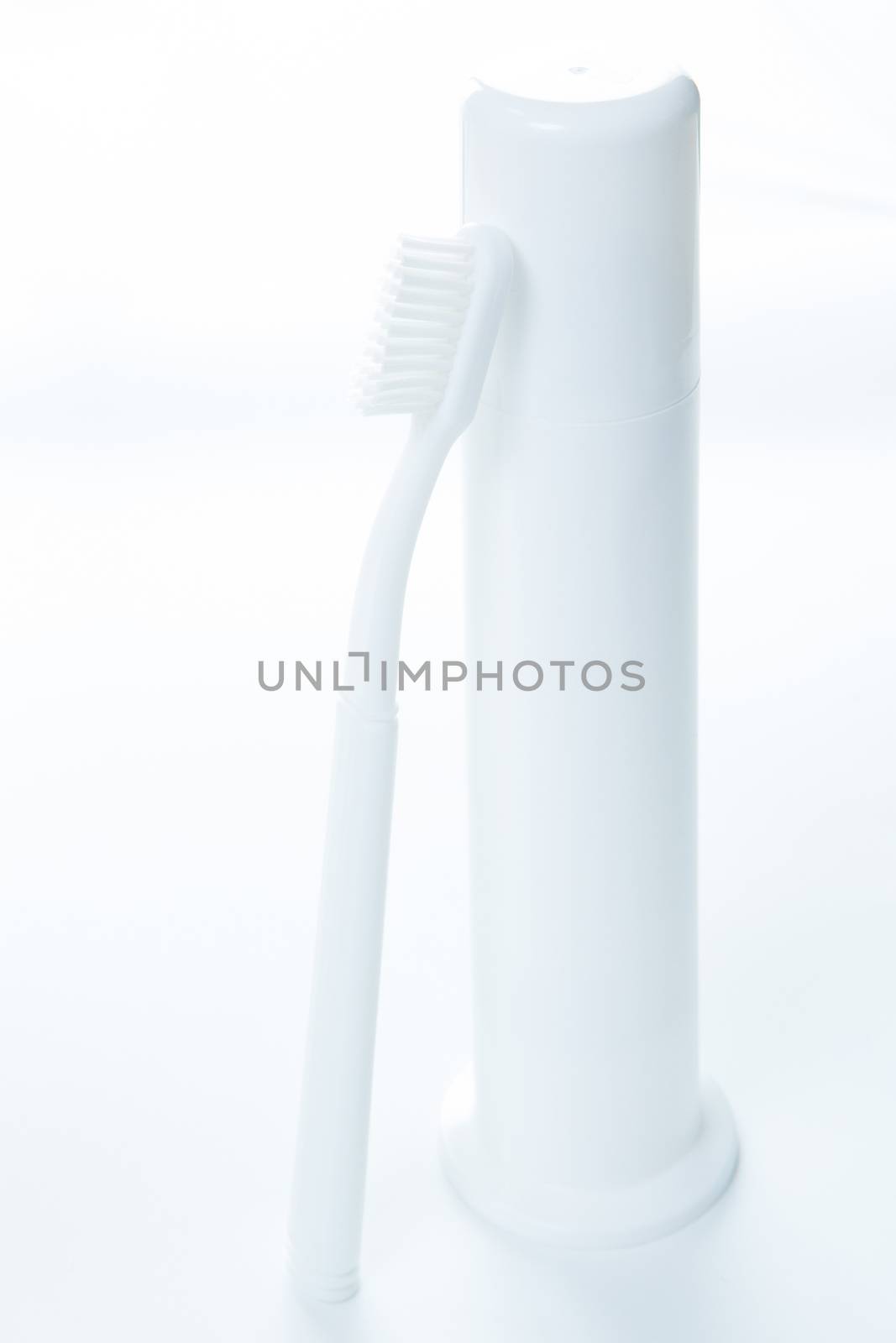 Toothpaste and toothbrush over white by sarymsakov