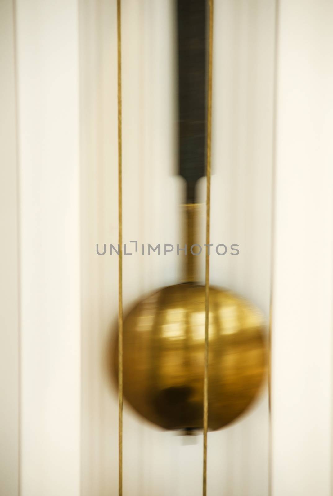 Abstract background of blur gold clocks, vertical shot.