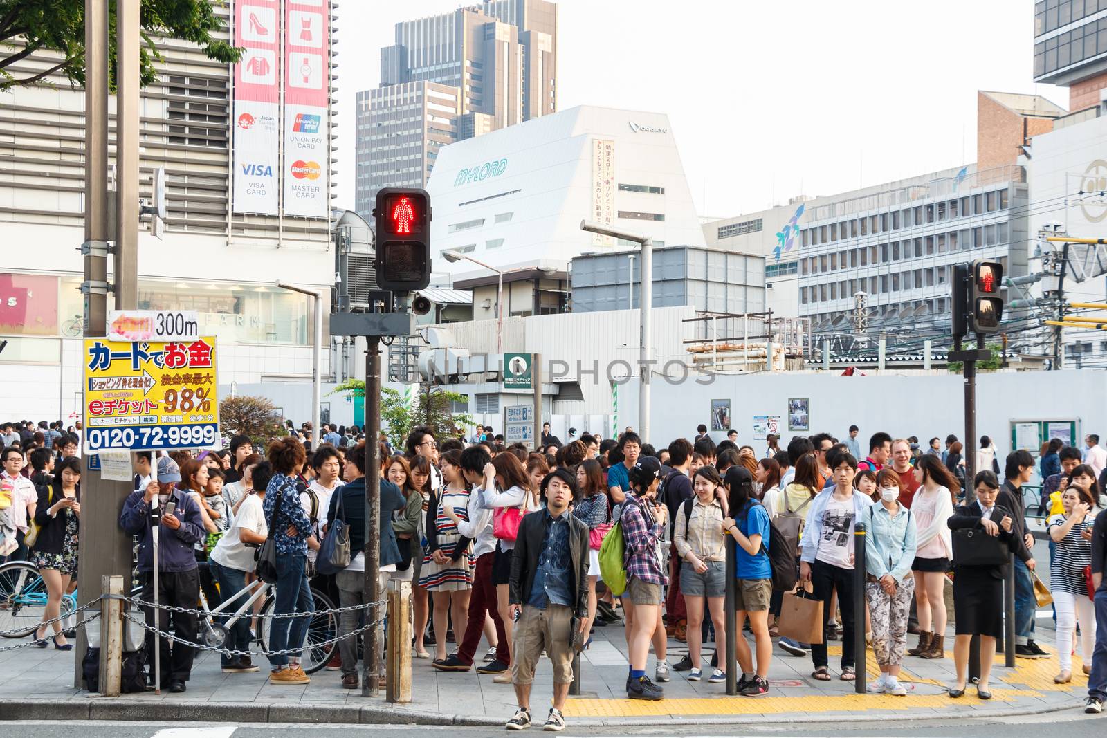 Tokyo ,Japan - May 25 ,2014. Many people cross the street and traffic light