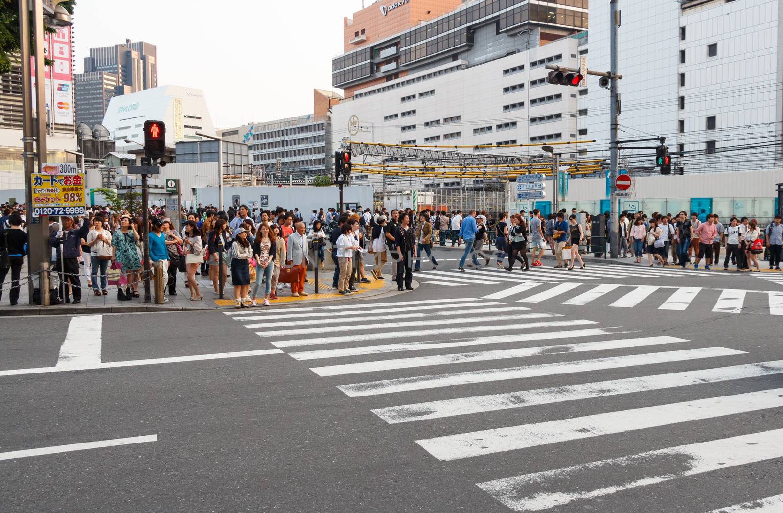 Tokyo ,Japan - May 25 ,2014. Many people cross the street and tr by stockdevil