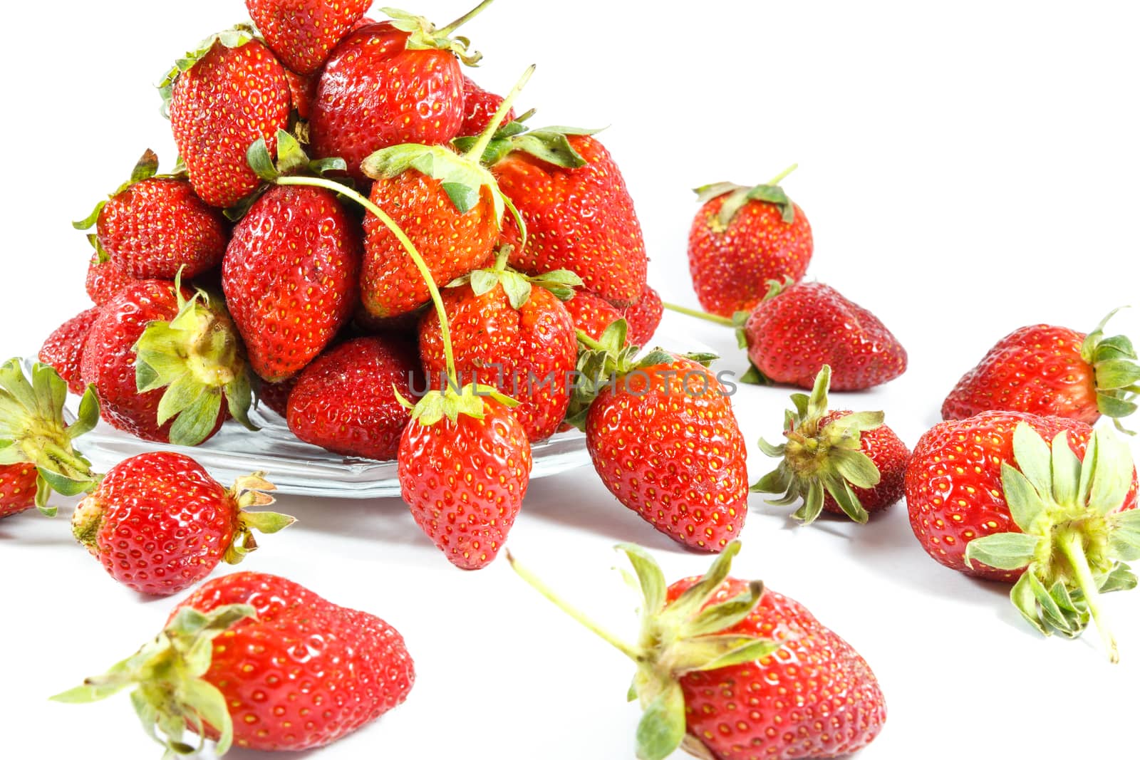 group of strawberries on plate and strawberry were scattered on white background (isolated)