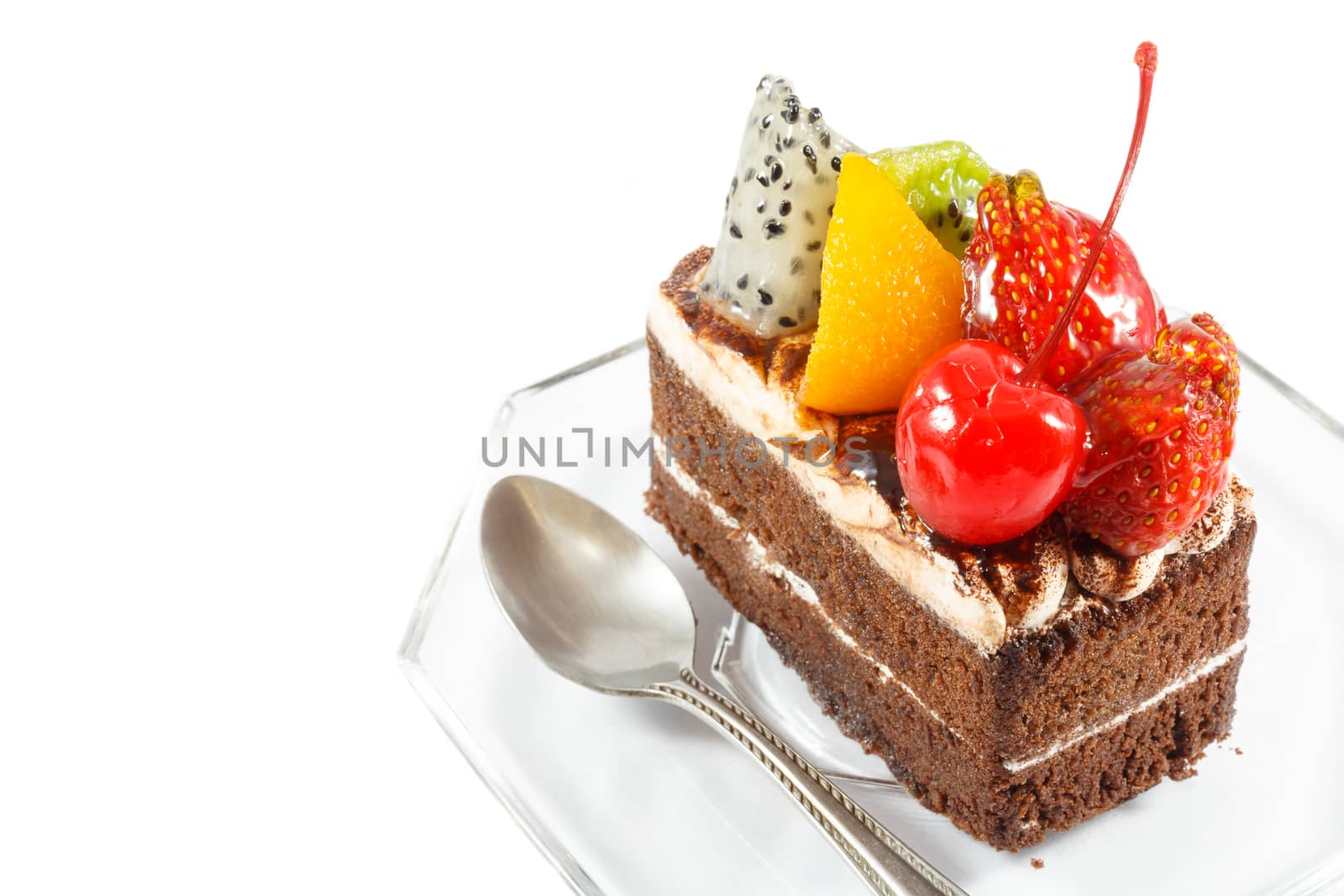fruitcake and spoon on white background (isolated) and blank area at left side