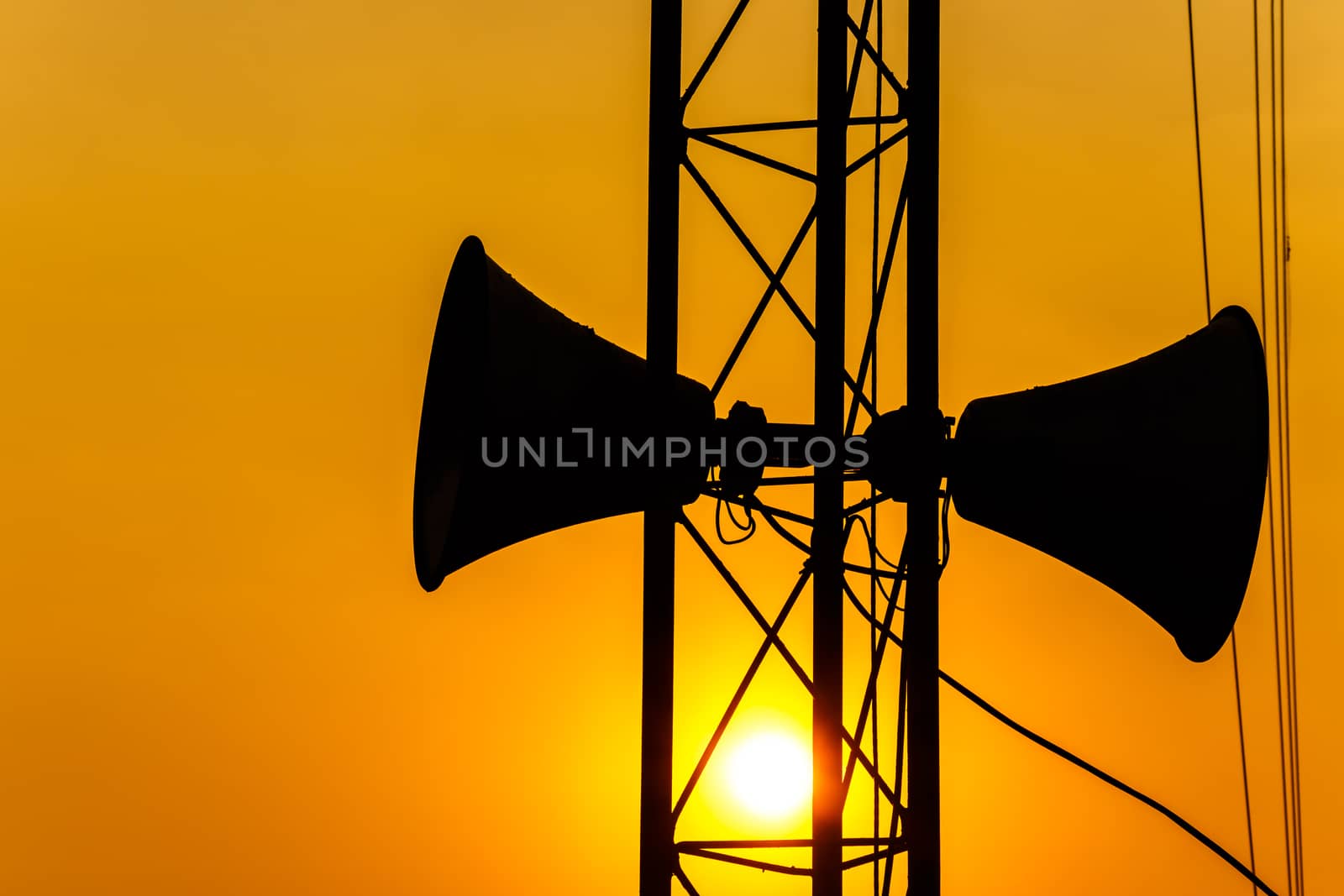 loudspeaker on pillar and sunset in the evening (silhouette) in Thailand