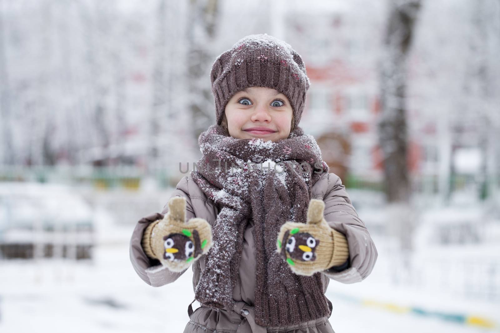 Happy little girl on the background of a winter park by andersonrise