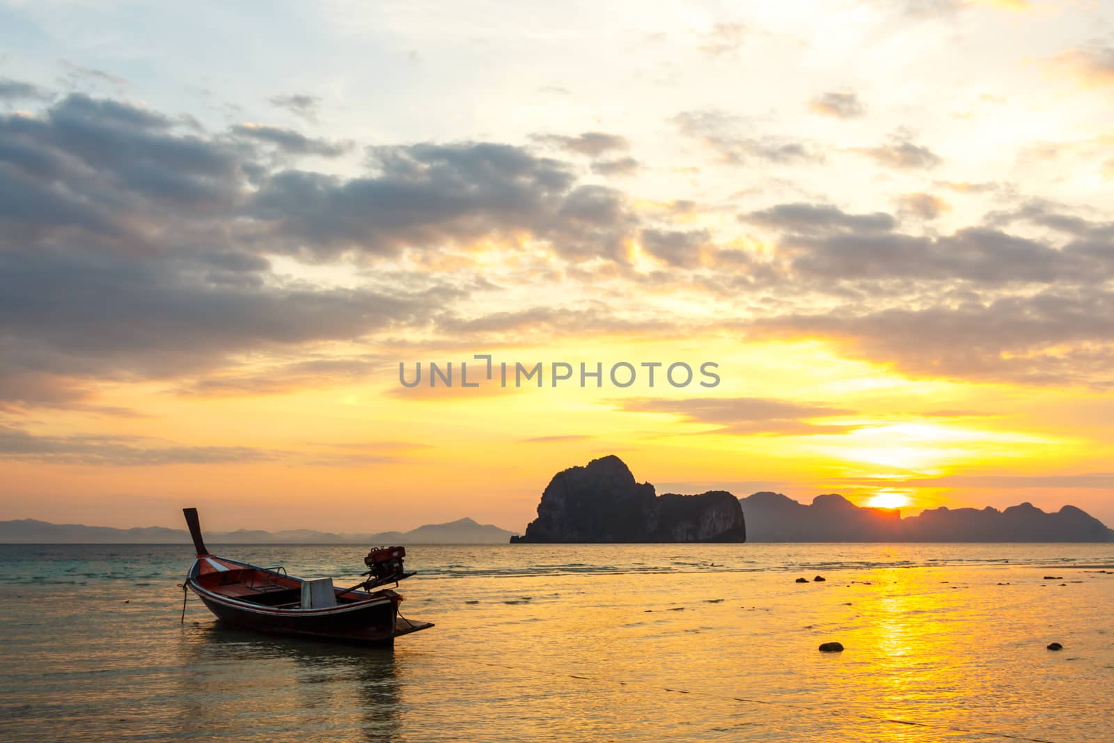 native boat on beach and sunrise in morning at Trang ,Thailand