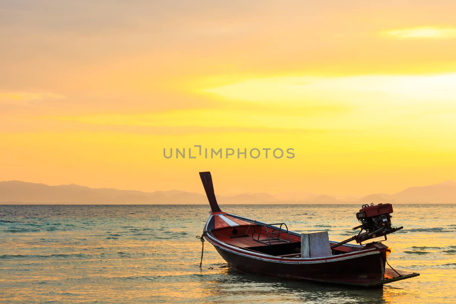 native boat on beach and sunrise in morning at Trang ,Thailand