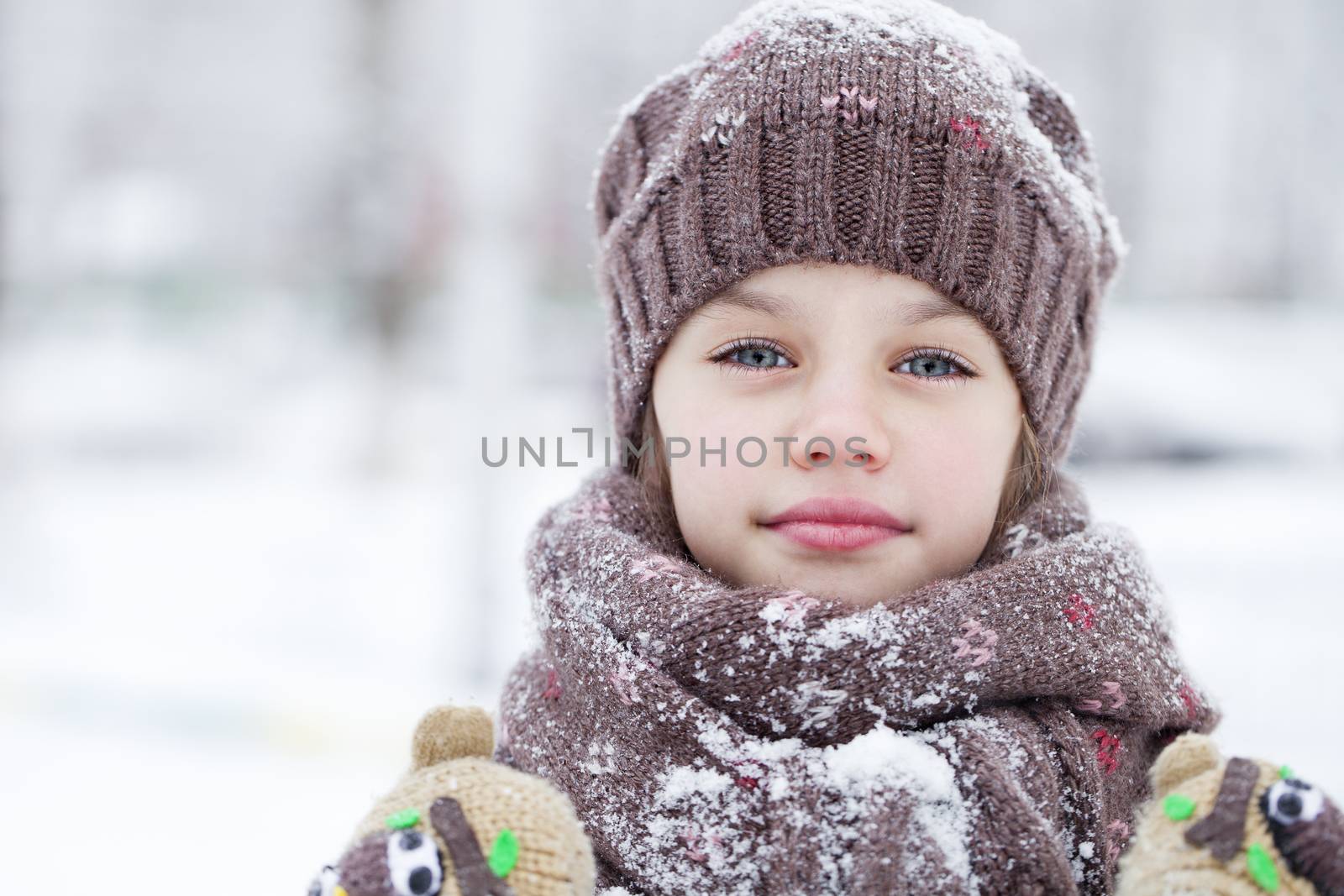 Happy little girl on the background of a winter park by andersonrise