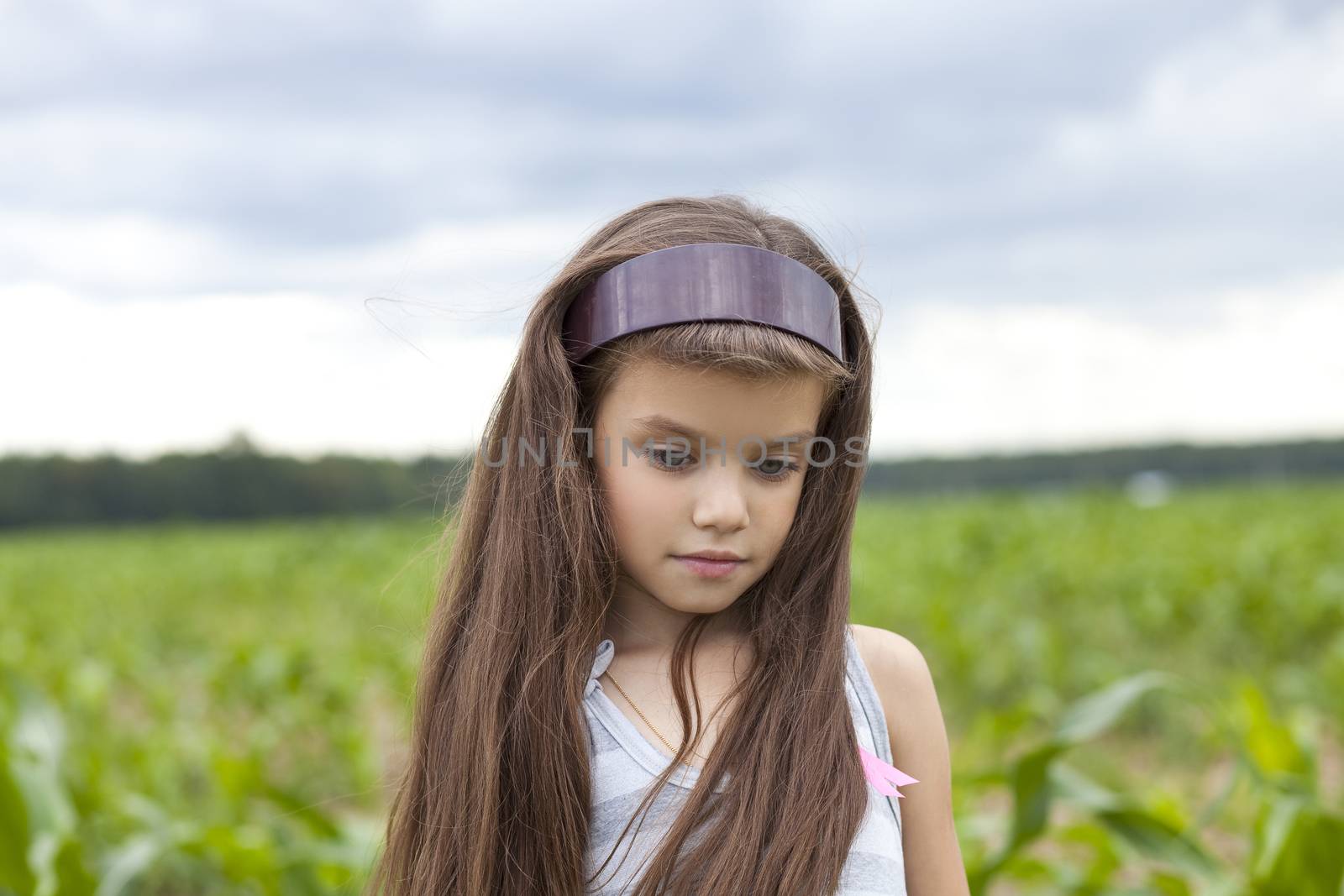 little girl running through the corn field