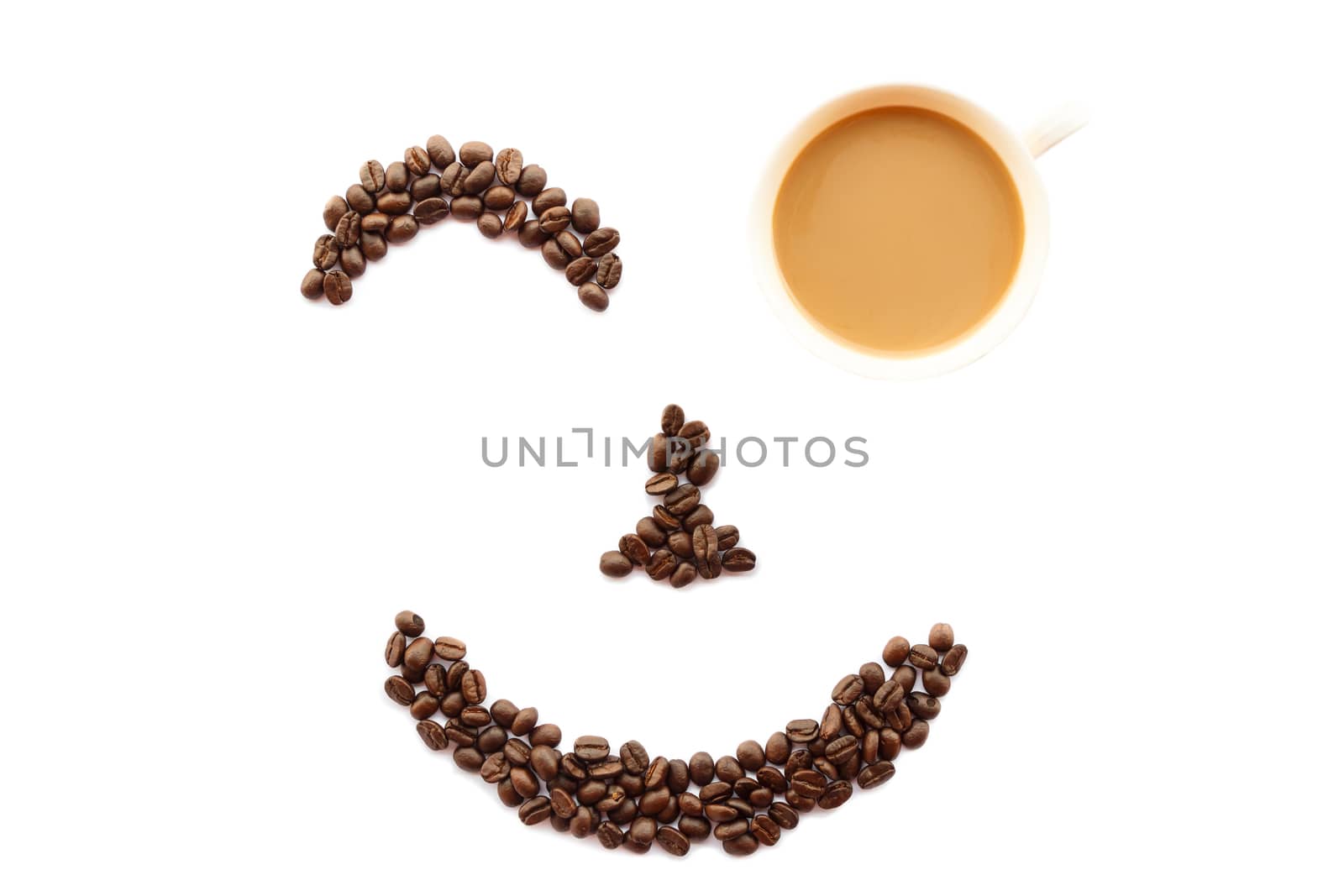 happy face shaped of coffee beans with cup on white background (isolated)