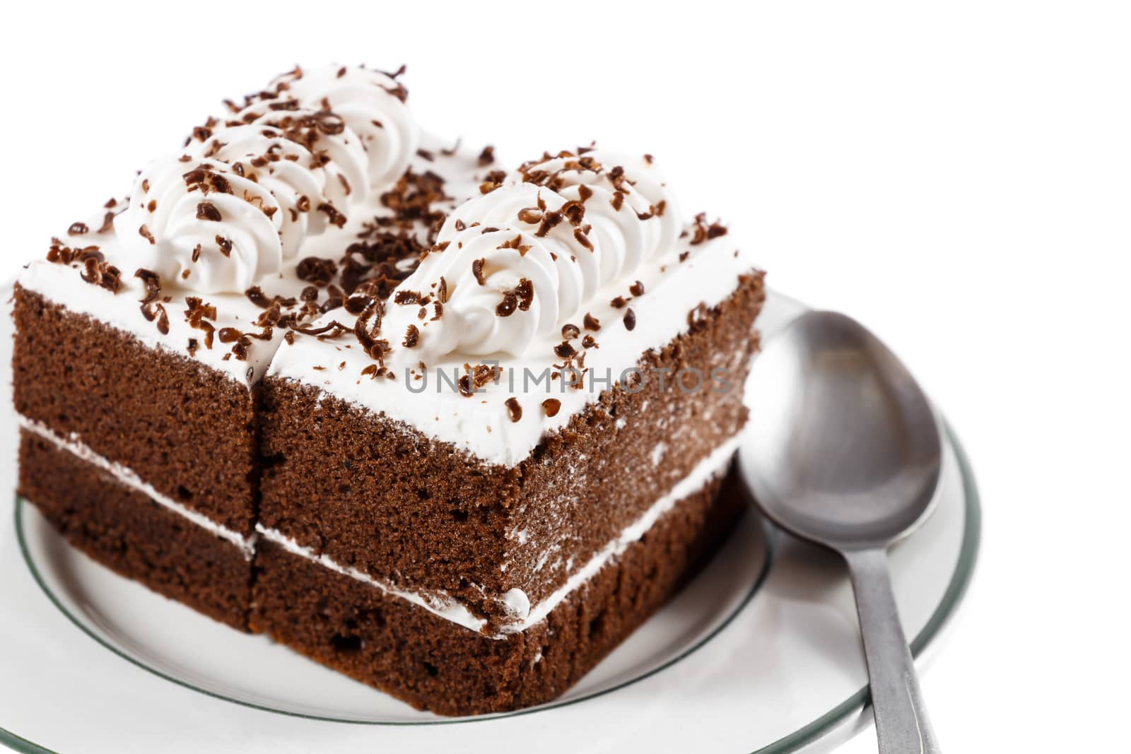 chocolate cakes with white cream on top and spoon on plate on white background(isolated) and blank area at right side