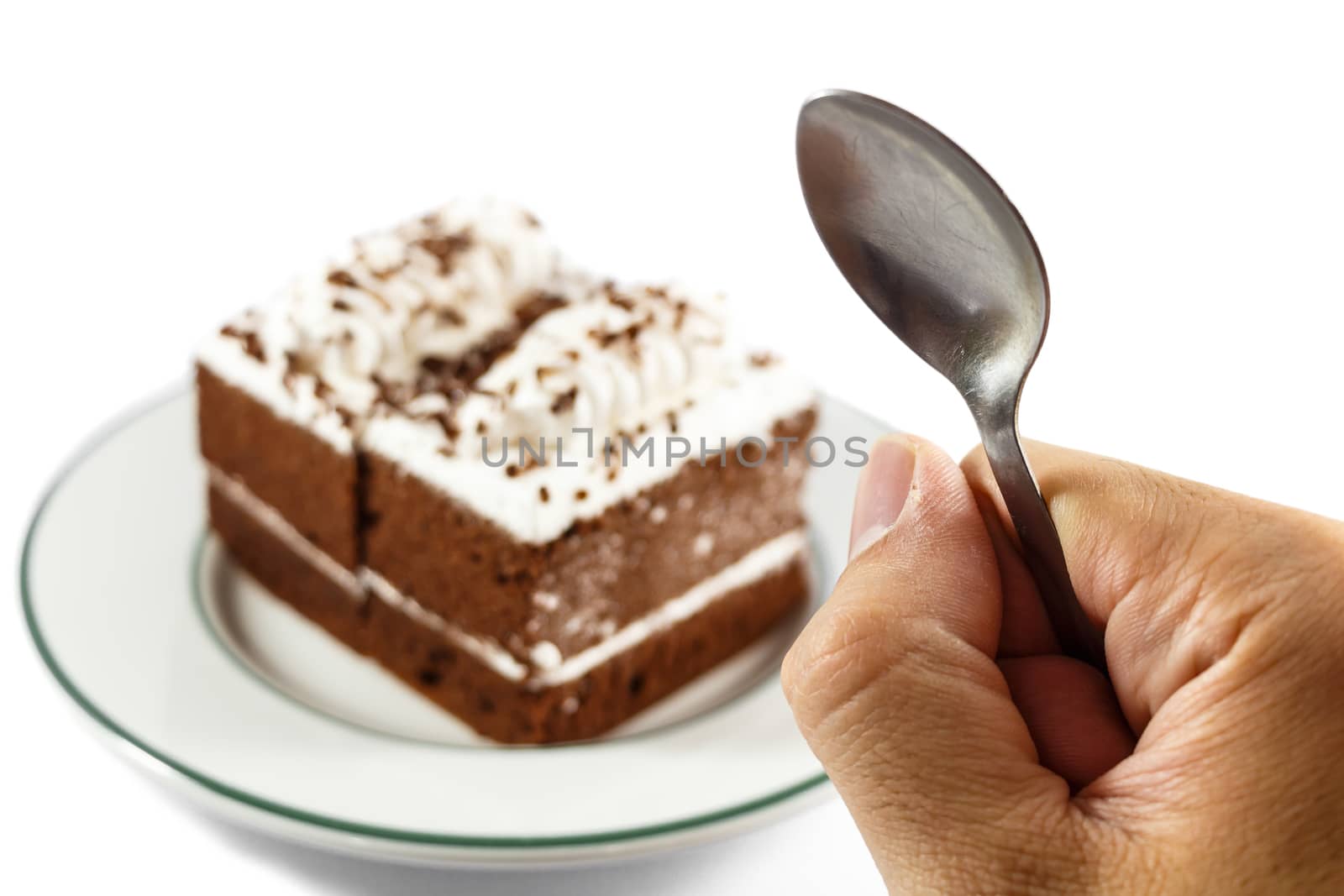 person hold spoon and chocolate cakes on white background