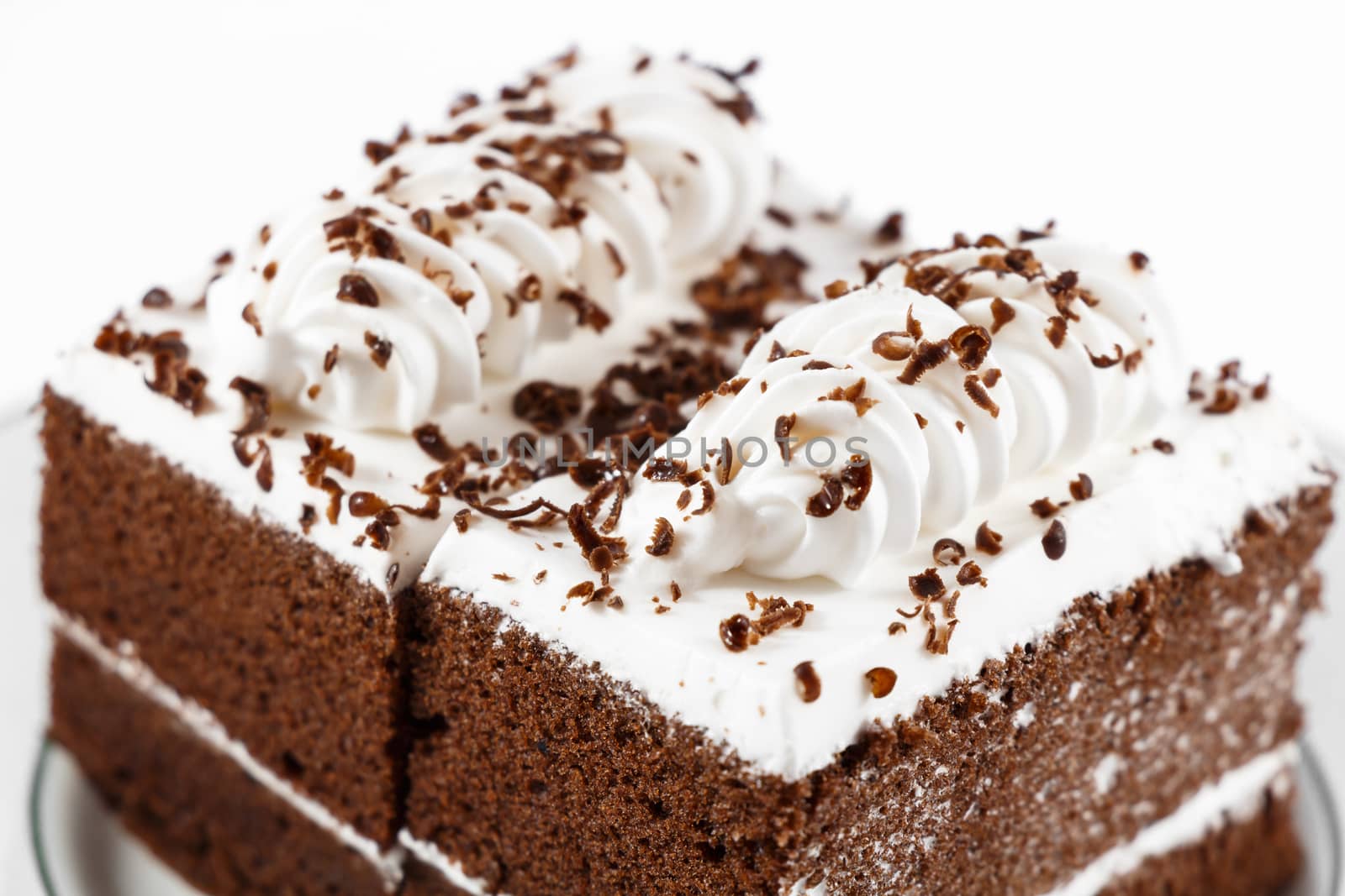 Chocolate cakes with white cream on top on white background