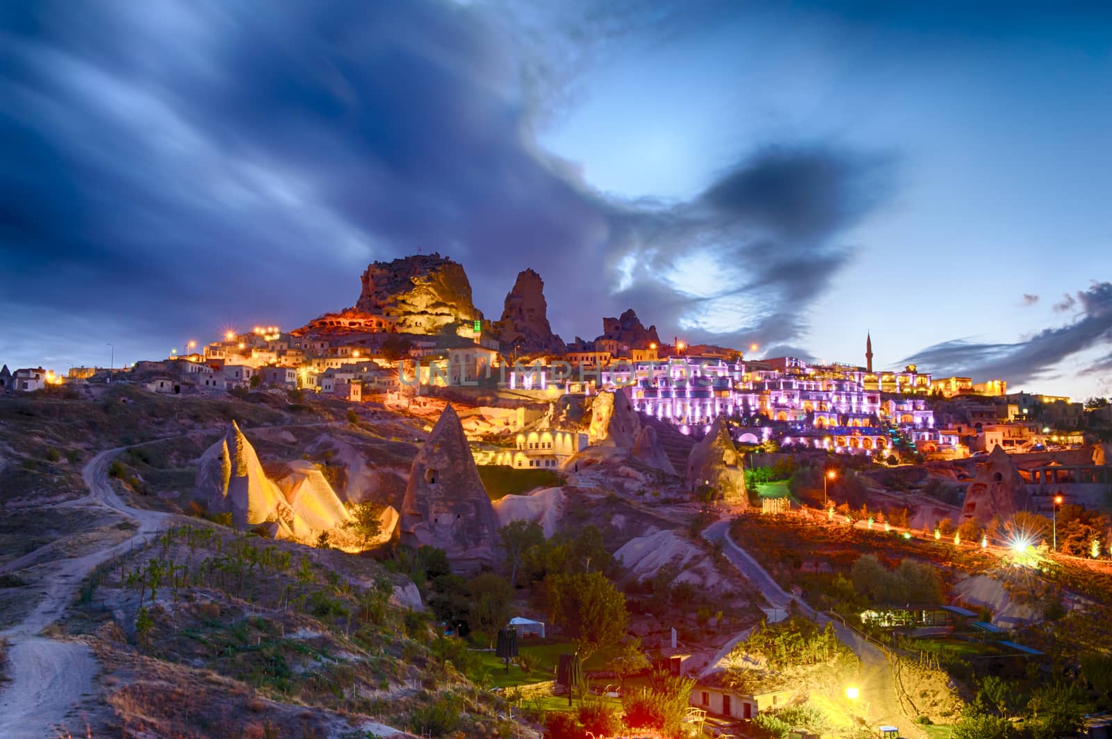 Ancient town and a castle of Uchisar dug from a mountains after twilight, Cappadocia, Turkey
