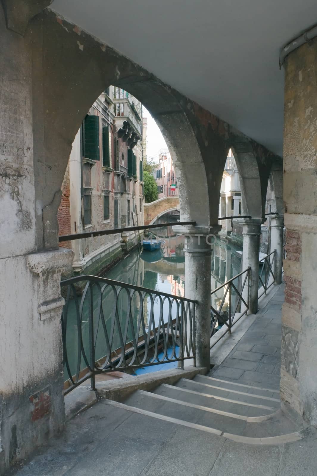 Venetian canal embankment with stairs and gallery