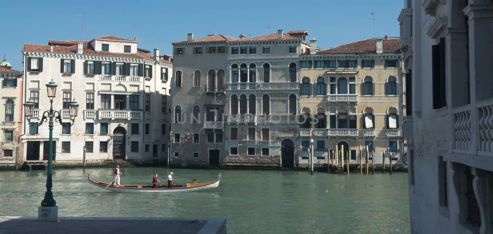 Gondola sailing on Grand Canal in Venice on a sunny spring morning
