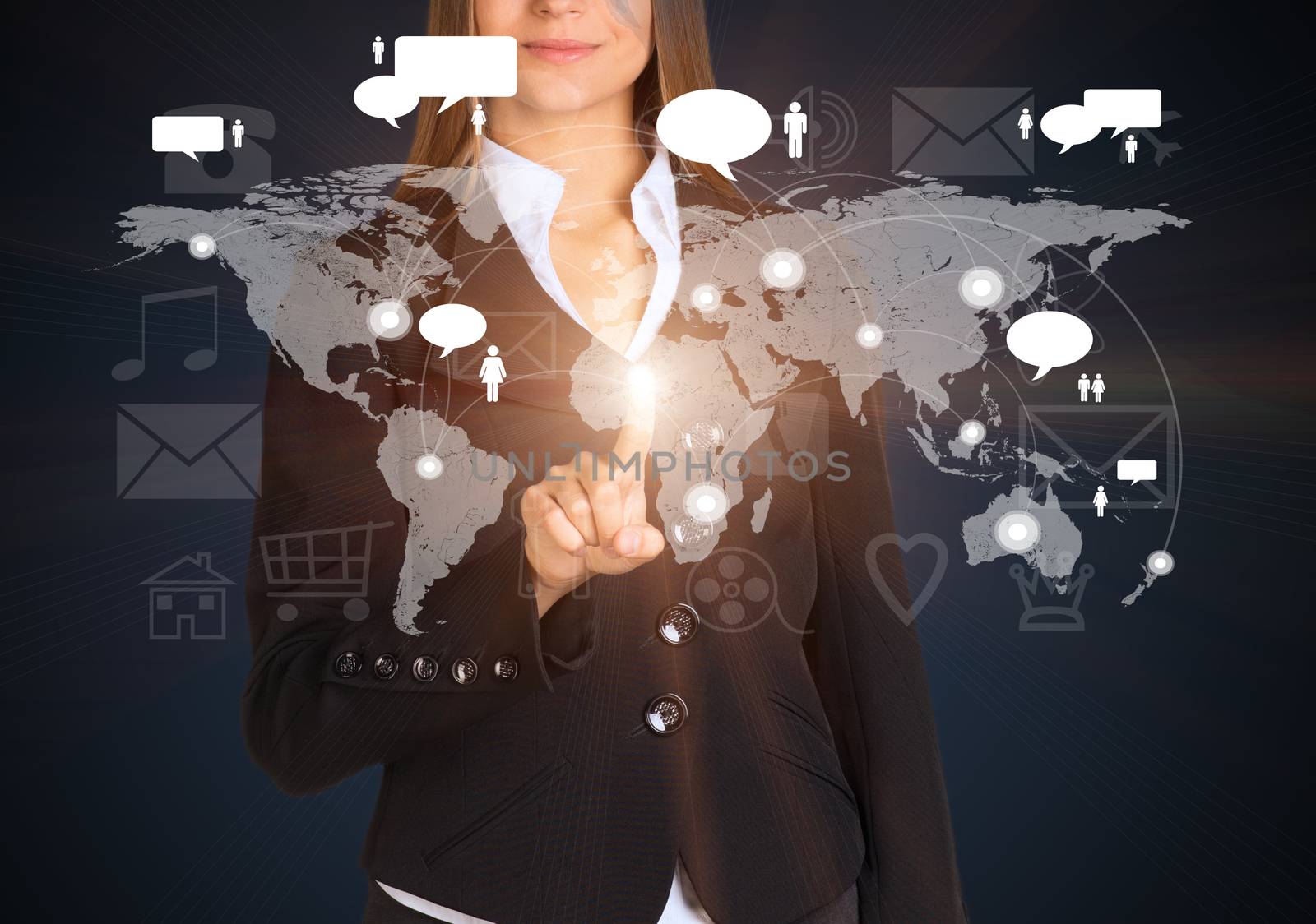 Businesswoman touches future style sensor screen on which there is map of the world with connection points and large icons. On dark background