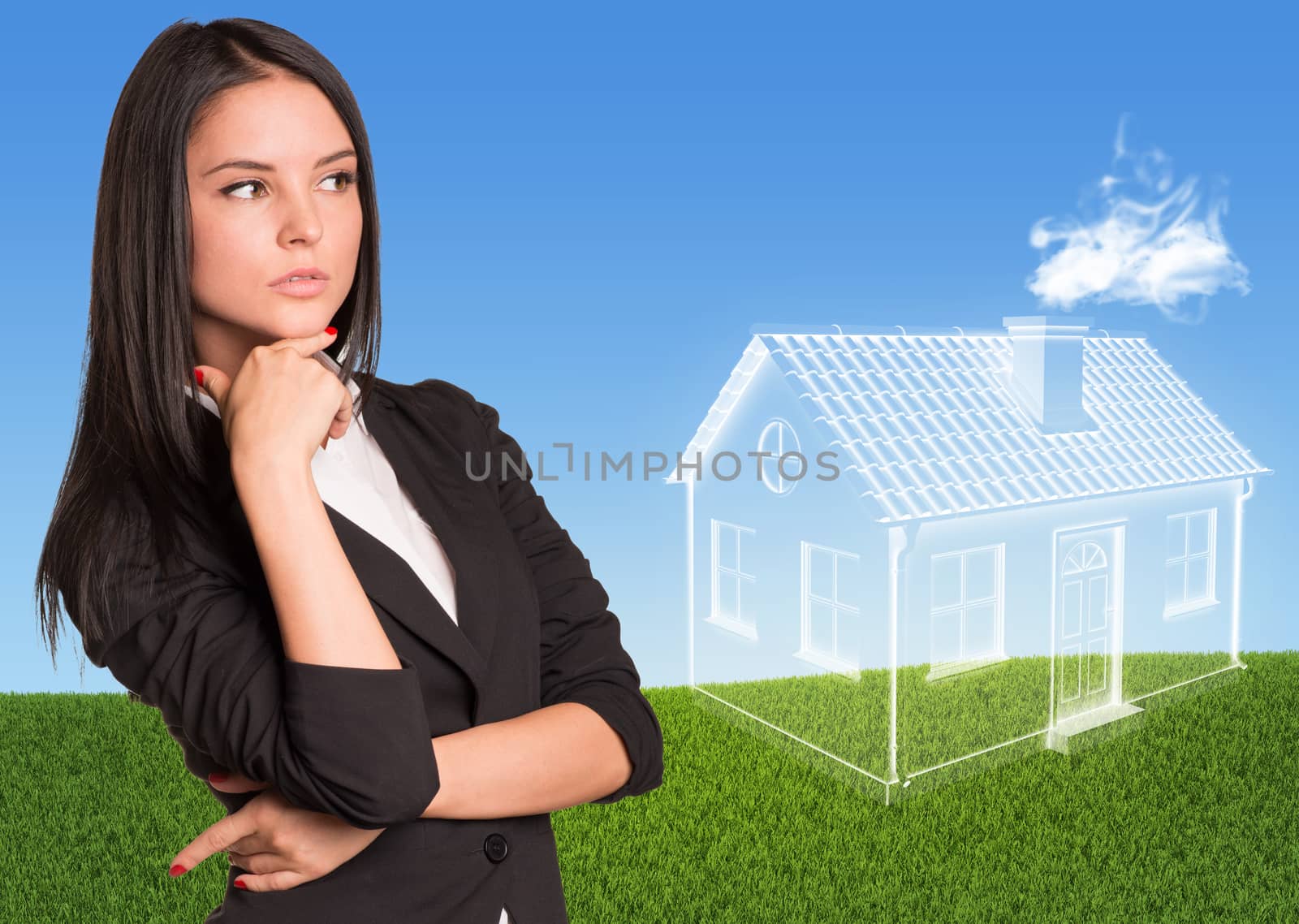 Businesswoman looking at imaginary house. Green lawn and sky as backdrop
