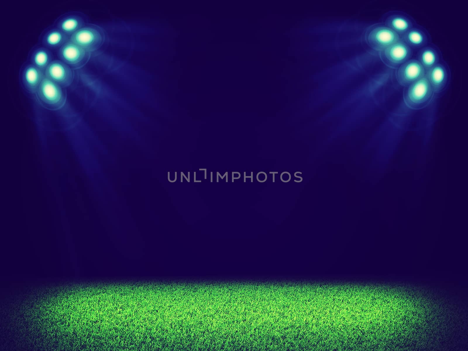 Spotlights illuminating area of green grass court in the dark