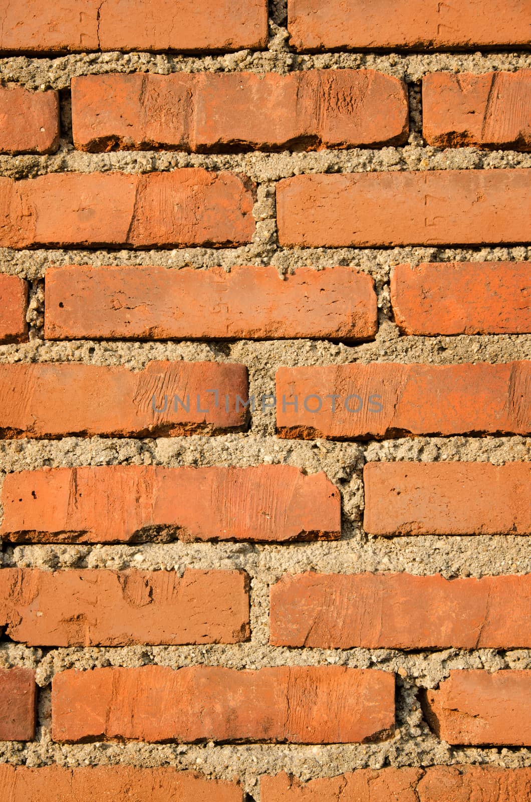 Brick and concrete wall texture background, vertical shot.