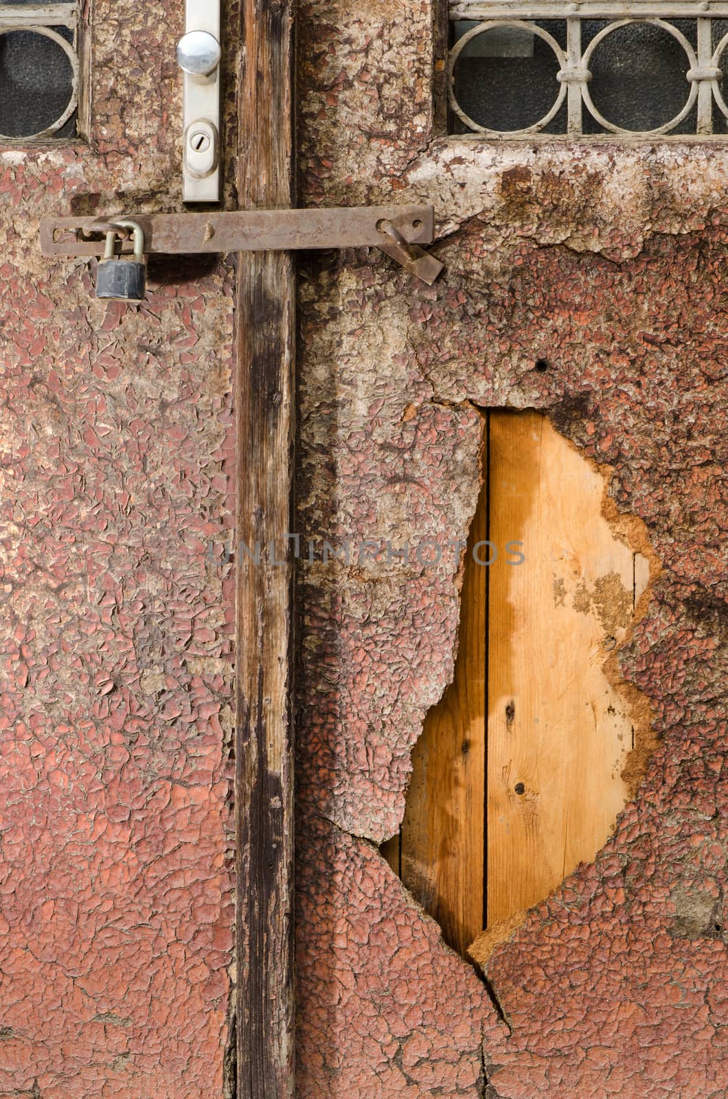 Texture of old painted wooden doors with hole.