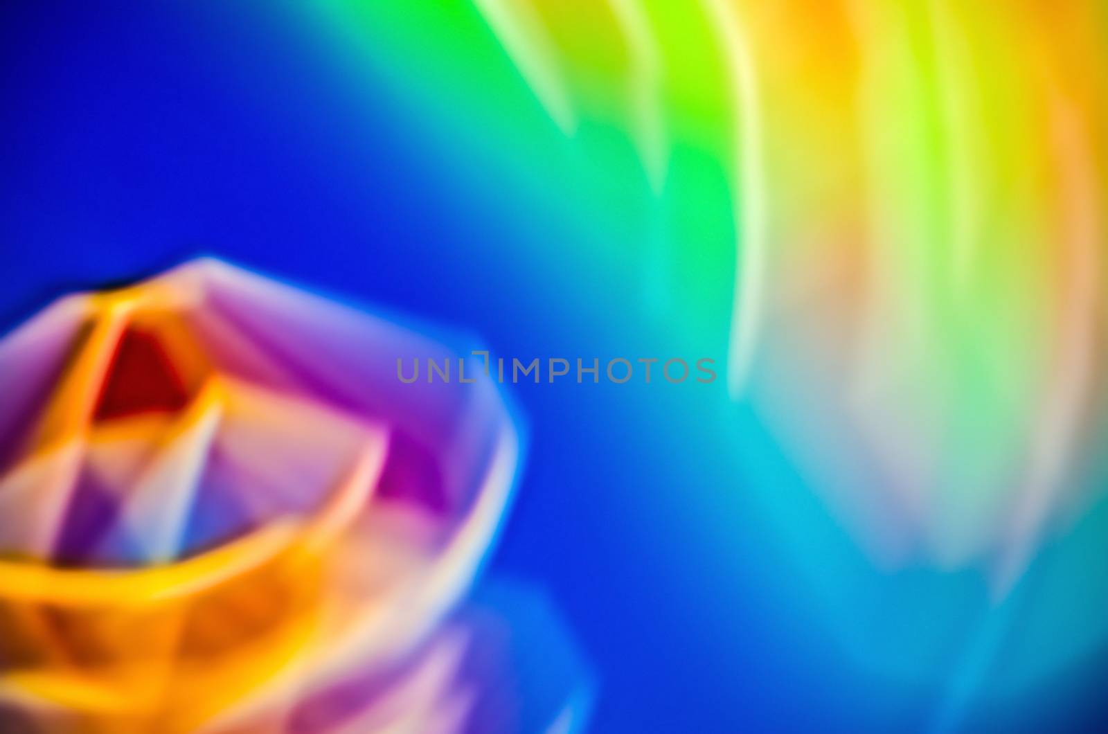 Multicolor blur background with fuzzy diamond in front.