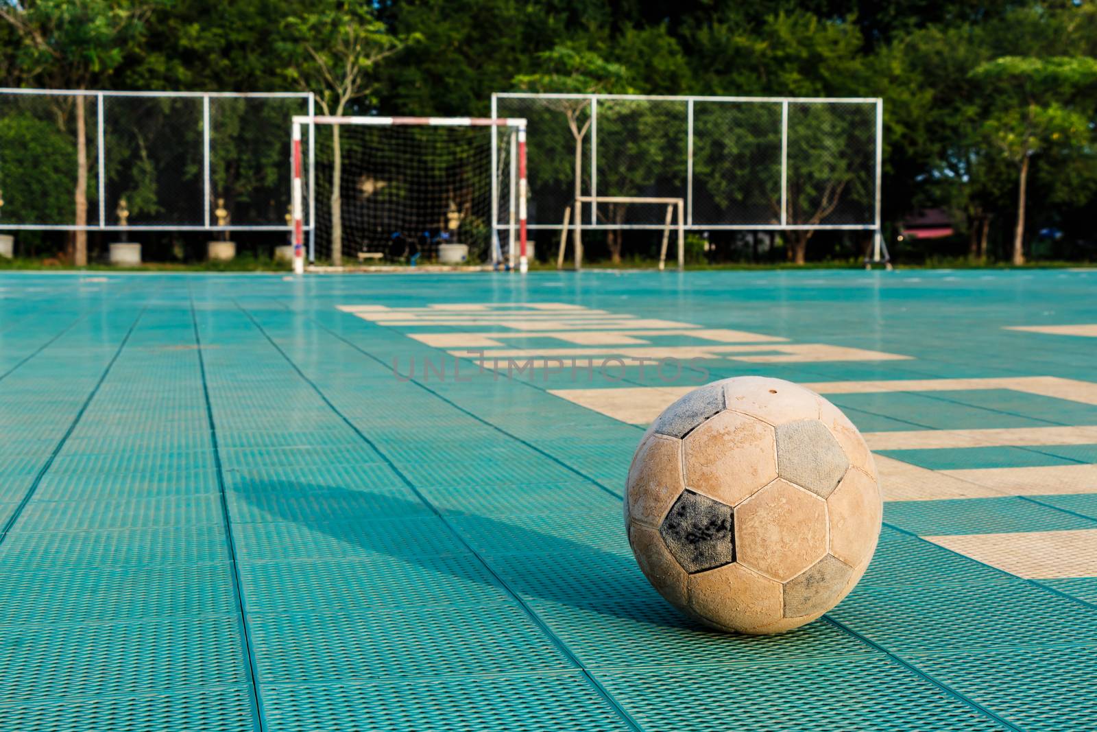 Old football on yard in rural school holiday