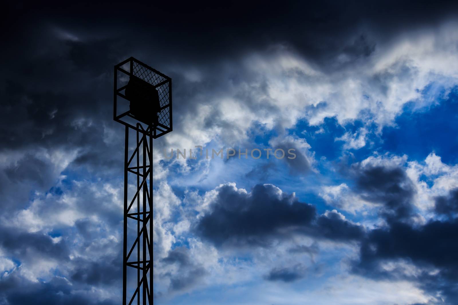 Spotlight and cloudy sky at rural school in Thailand (silhouette style)