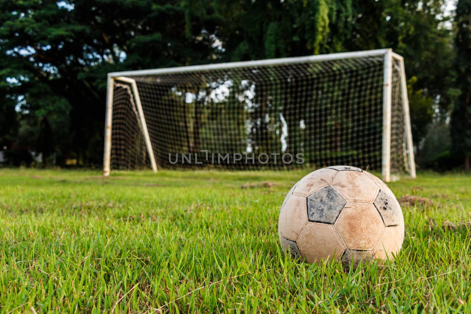 Old football on lawn in rural school