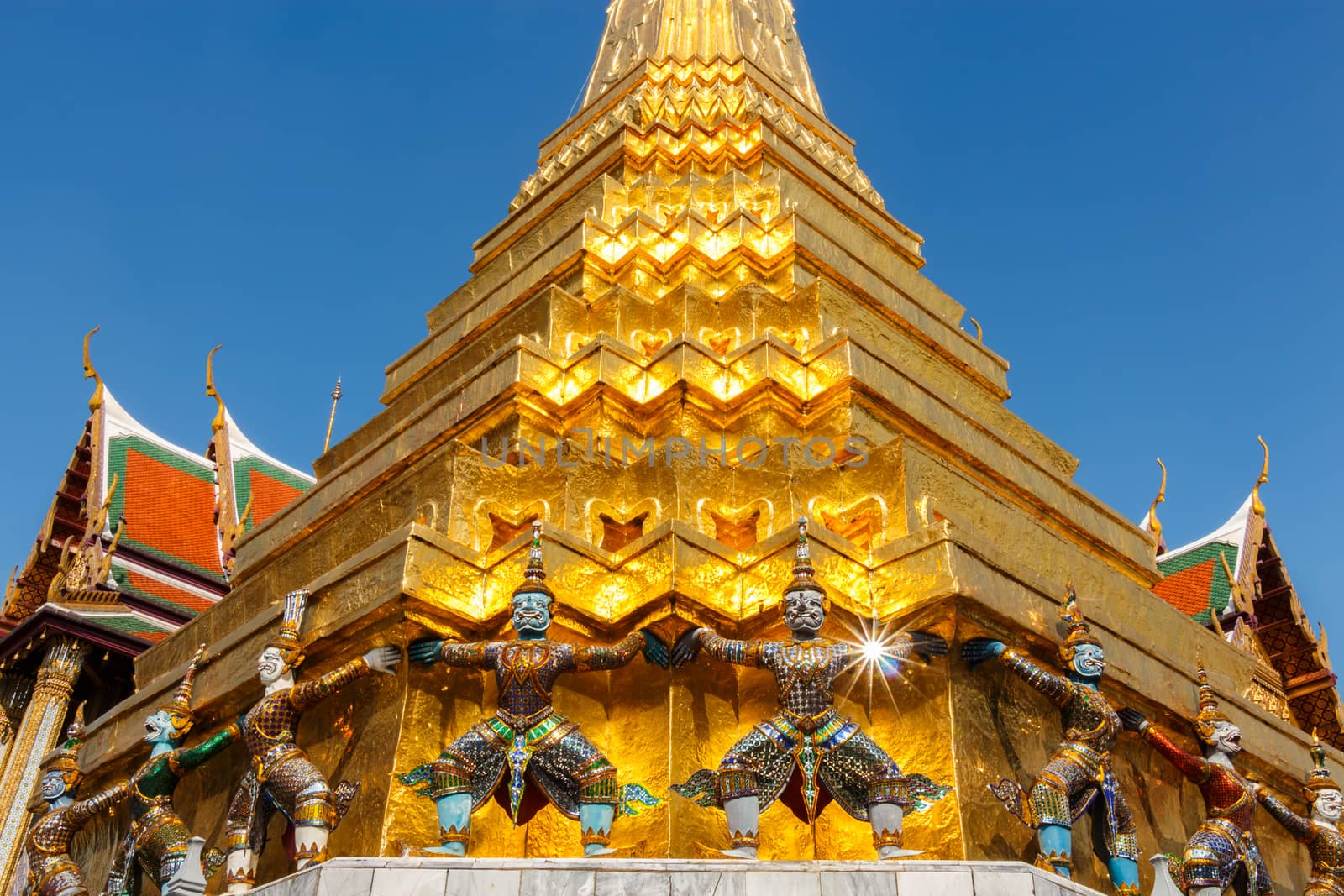 giant statue hold base of pagoda at Wat Phra Kaew ,Thailand