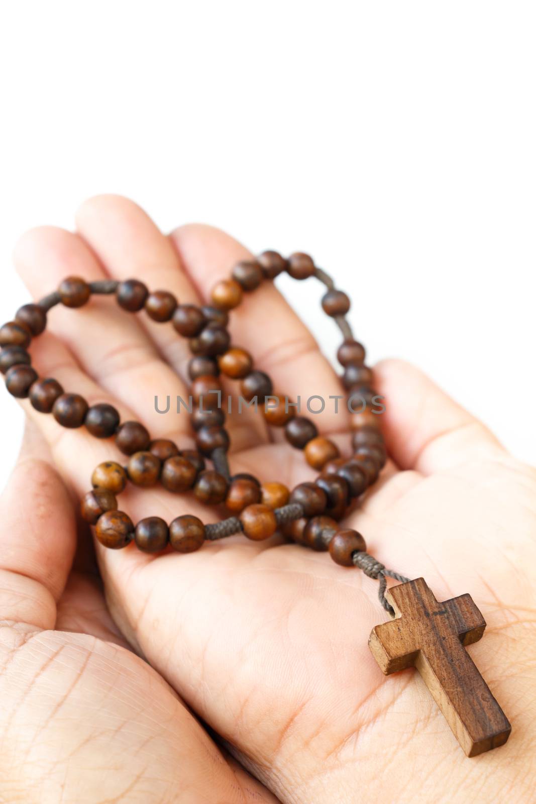 wood rosary with cross on palm of human