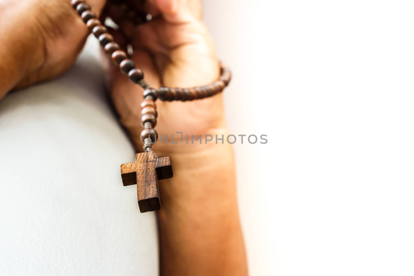 human pray to god with wood rosary