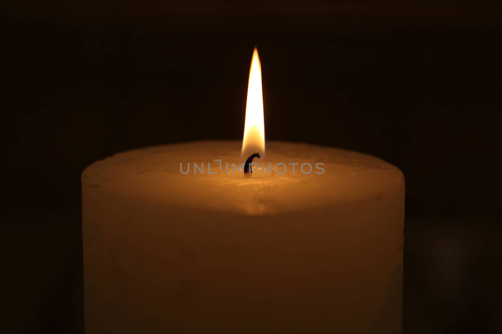 candle burning on a black background