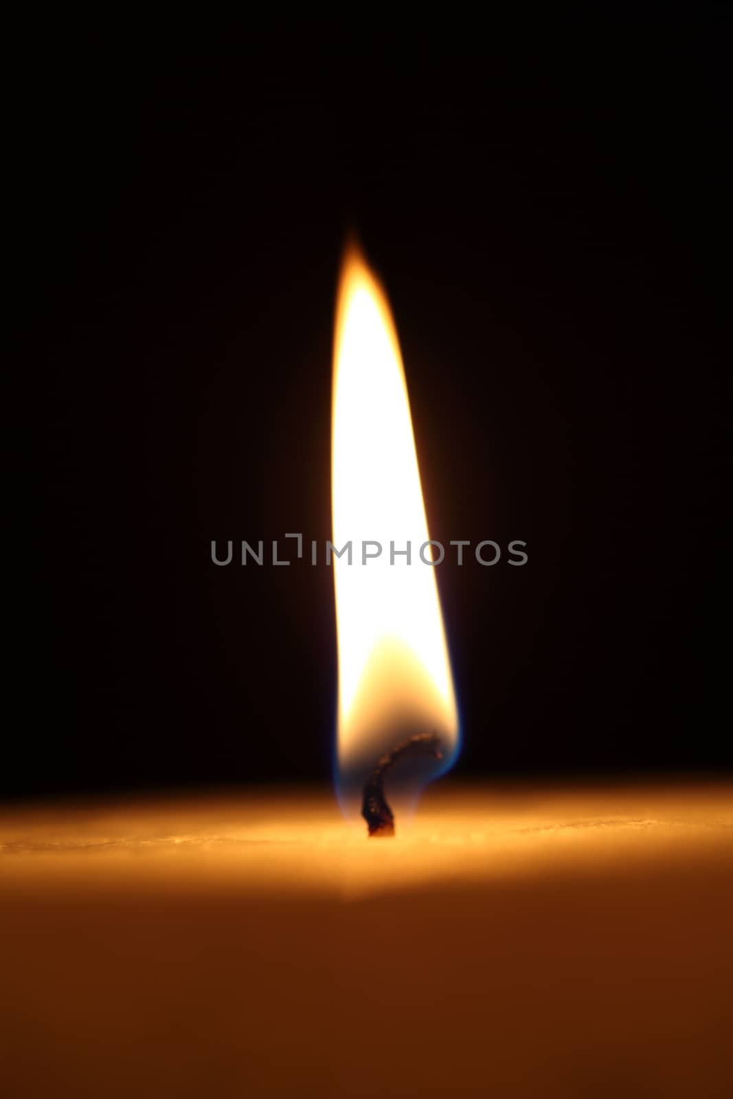 candle burning on a black background