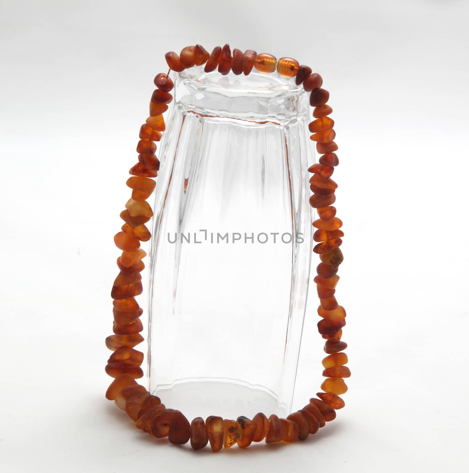 glass with amber necklace