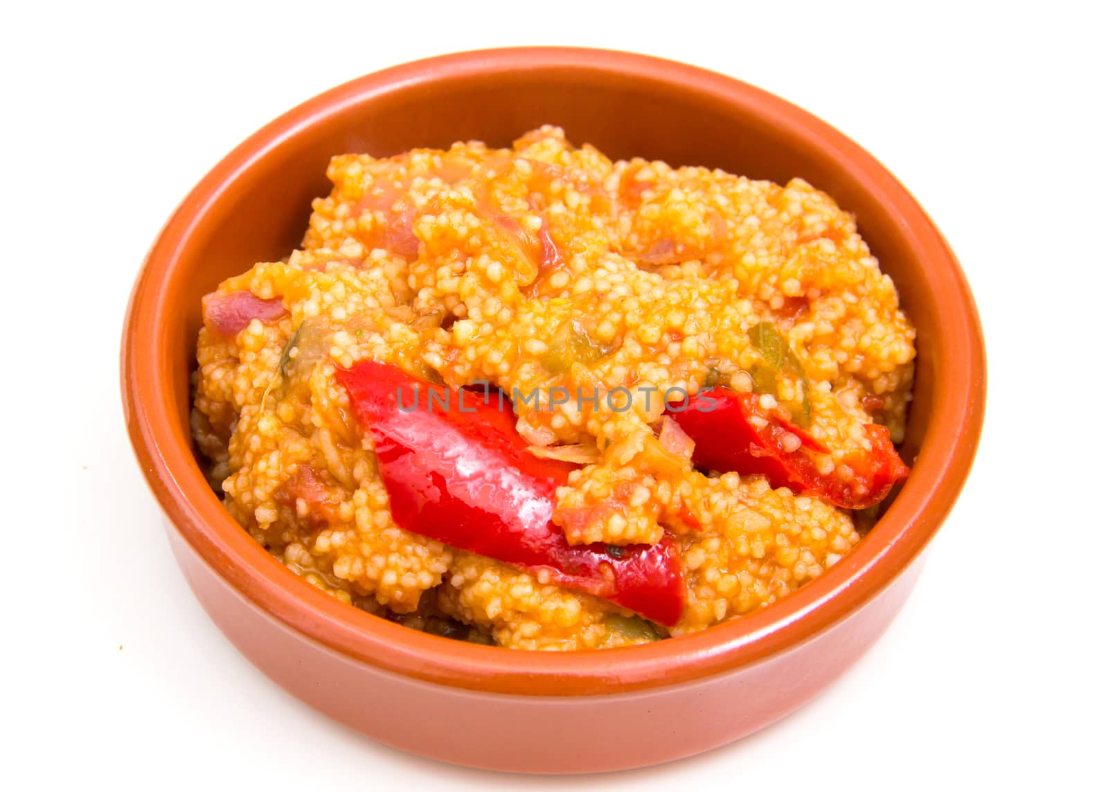 Couscous with vegetables on a bowl over white background