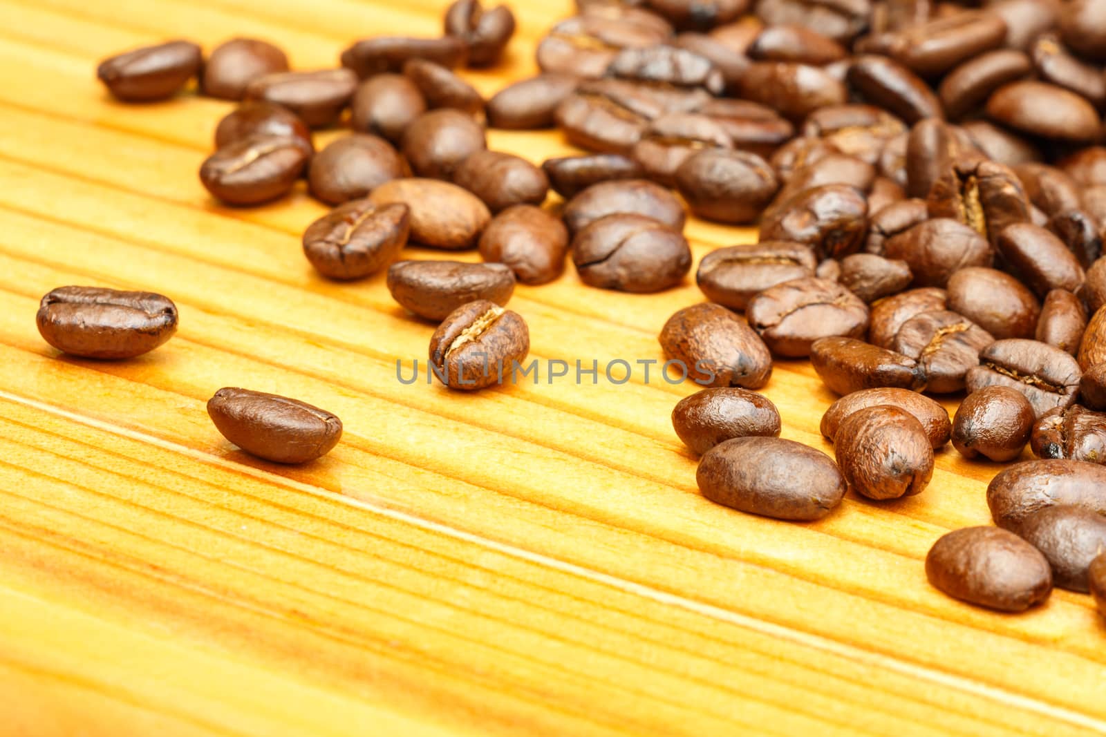 coffee beans on wooden table by stockdevil