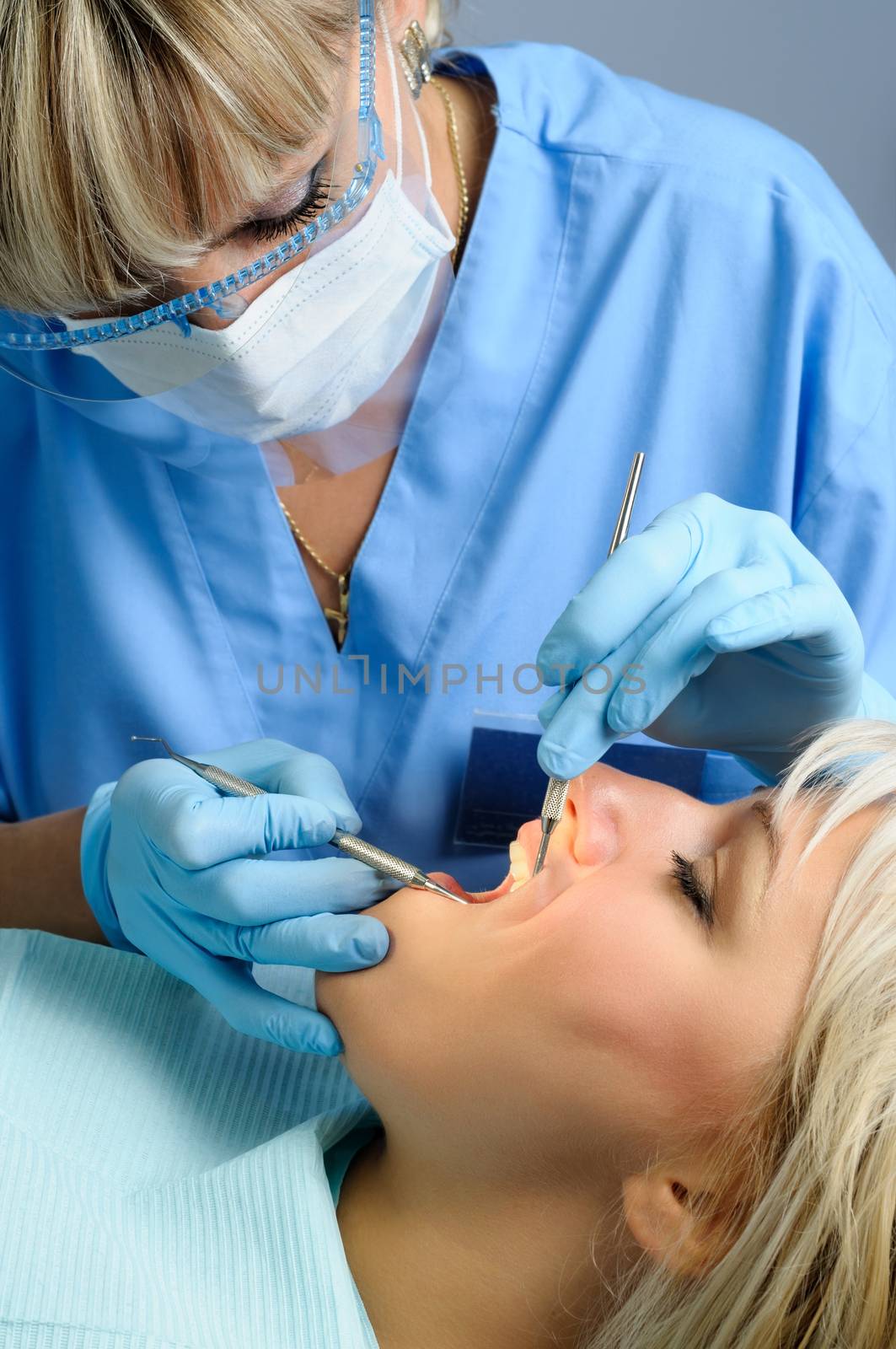 dentist at work with patient, dental exam and calcucus removal
