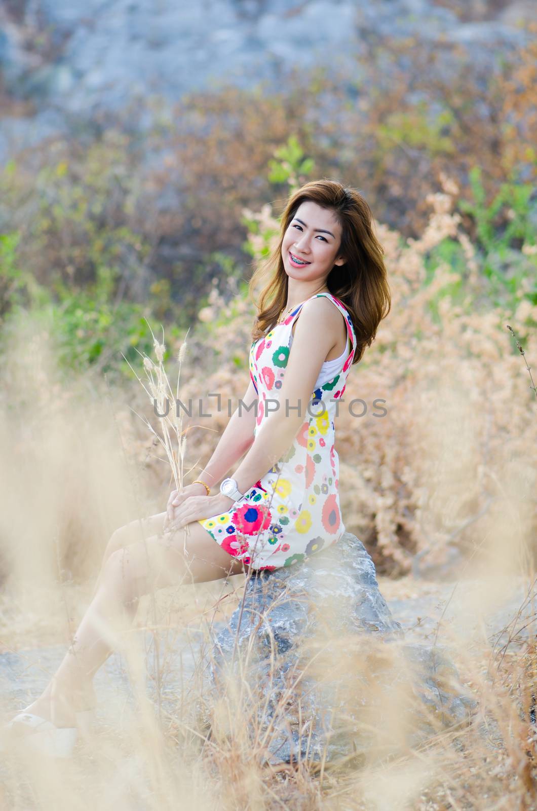 Portrait of woman on meadow, model is a asian girl. by chatchai