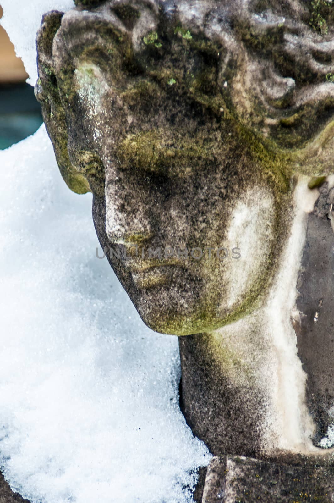 detail of a mourning sculpture on a cemetery