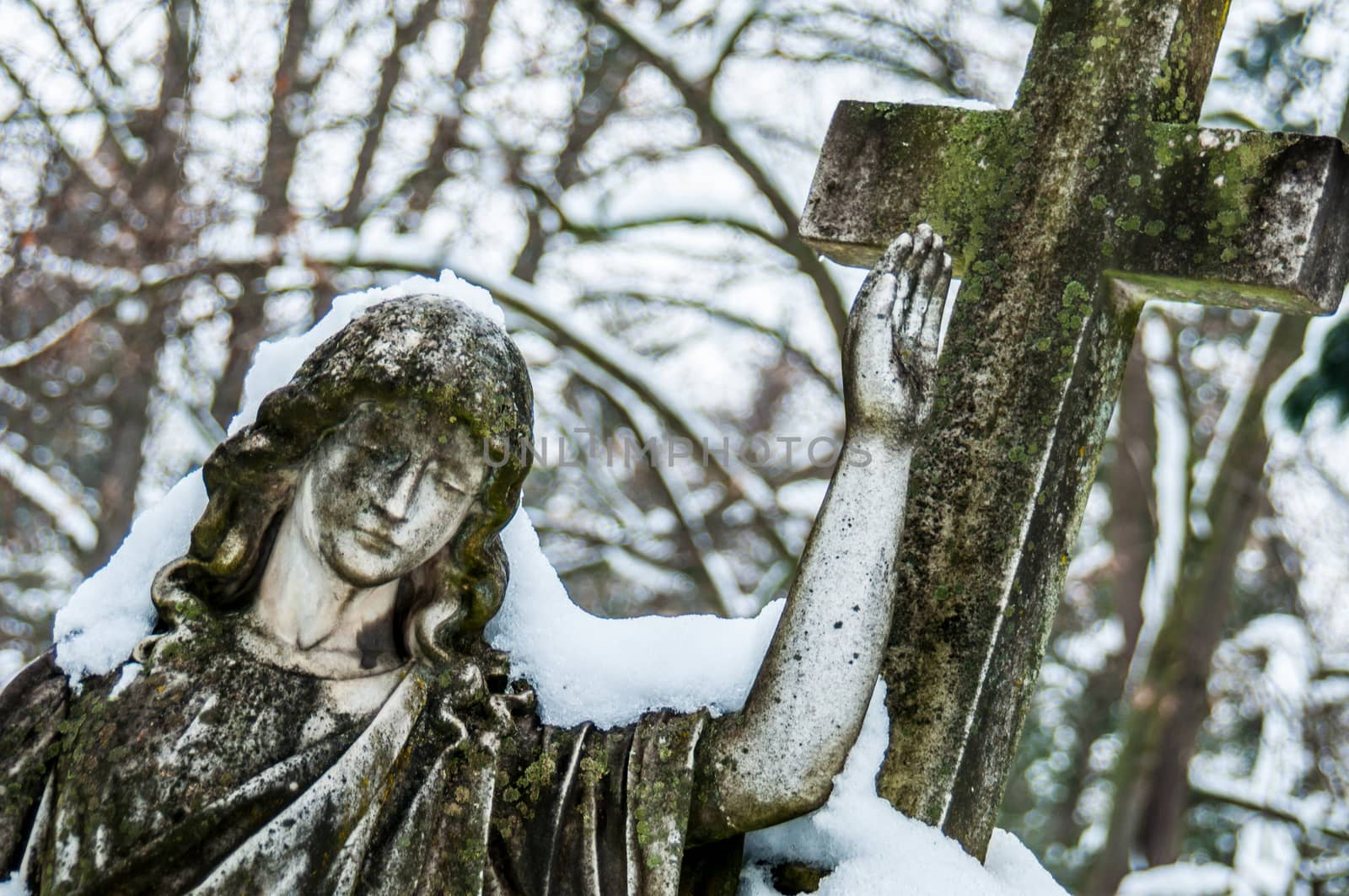 detail of a mourning sculpture on a cemetery