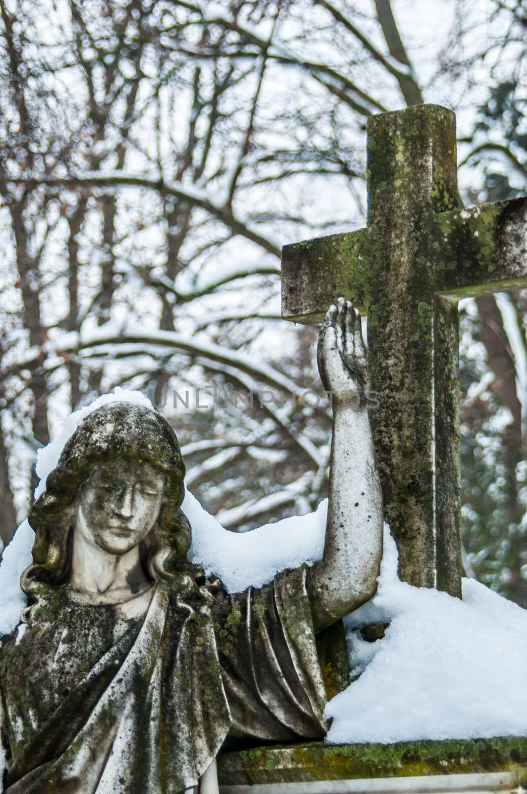 detail of a mourning sculpture on a cemetery