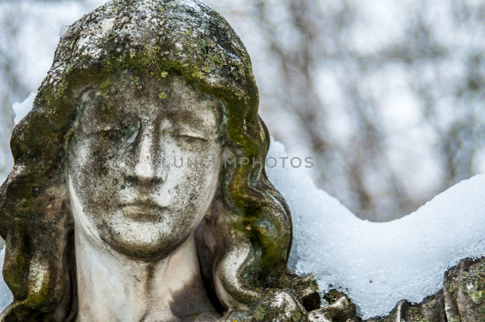 detail of a mourning sculpture on a cemetery