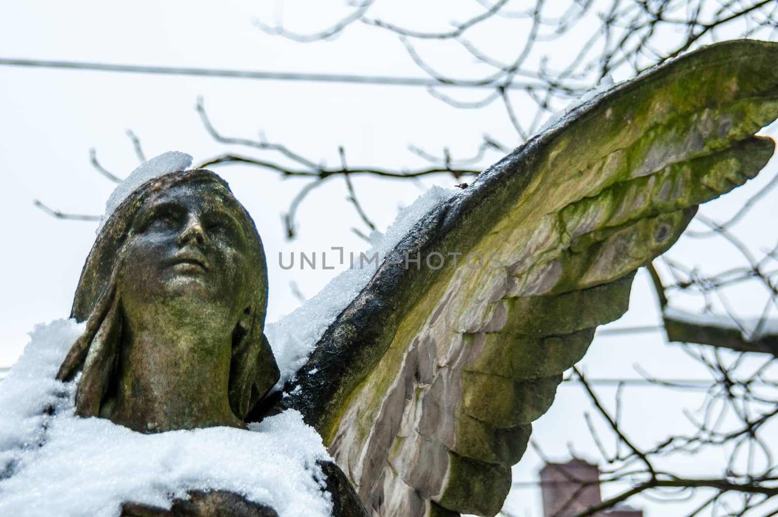 detail of a mourning sculpture on a cemetery