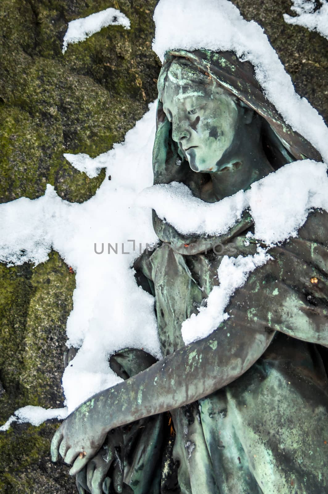 detail of a mourning sculpture on a cemetery