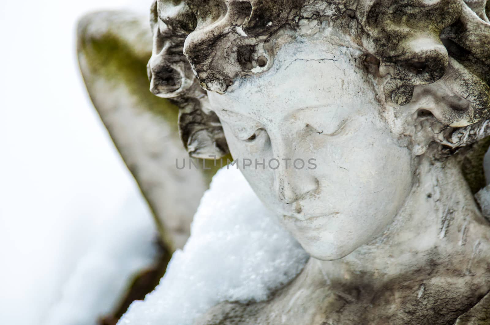 detail of a mourning sculpture on a cemetery