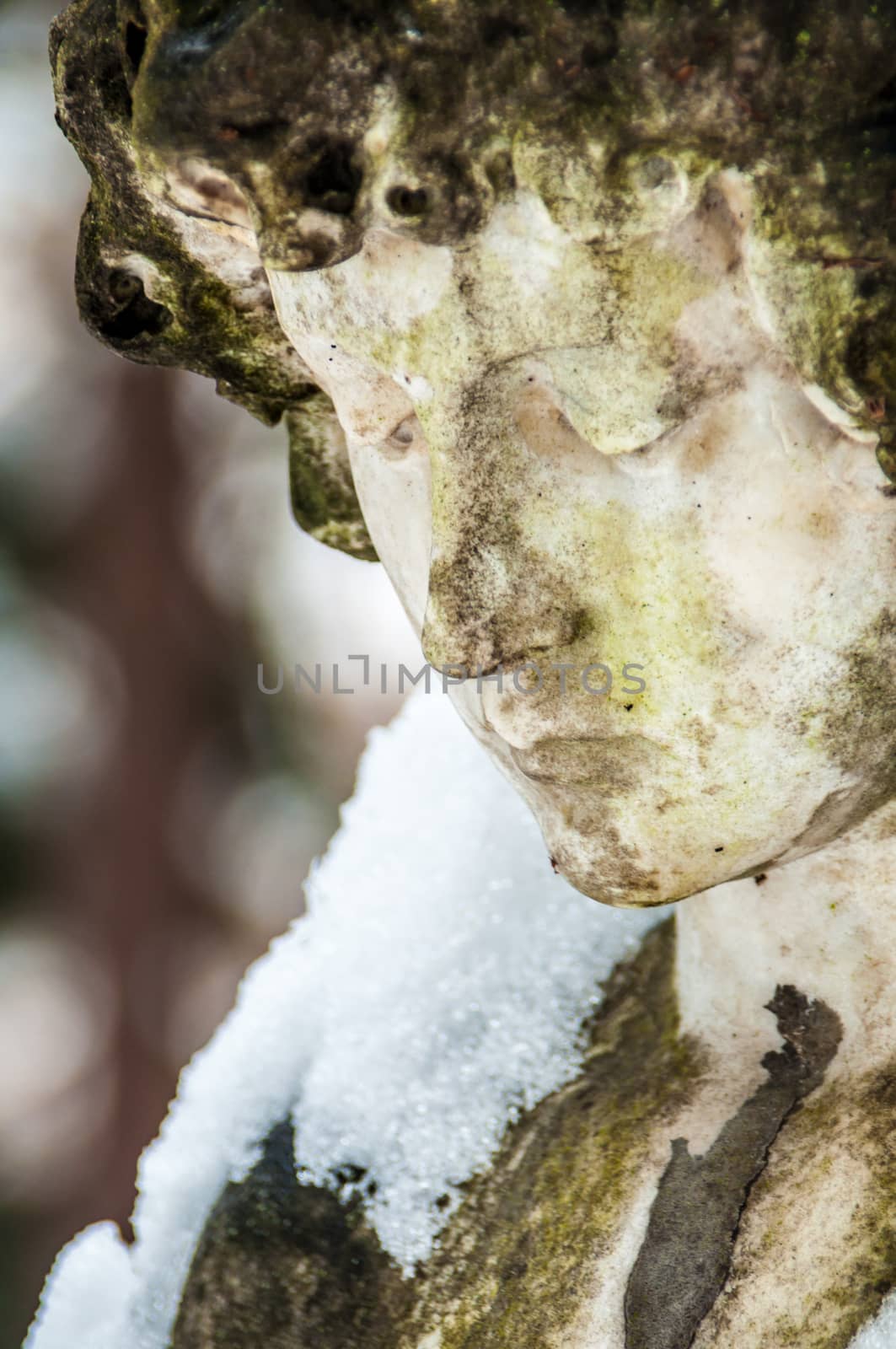 detail of a mourning sculpture on a cemetery