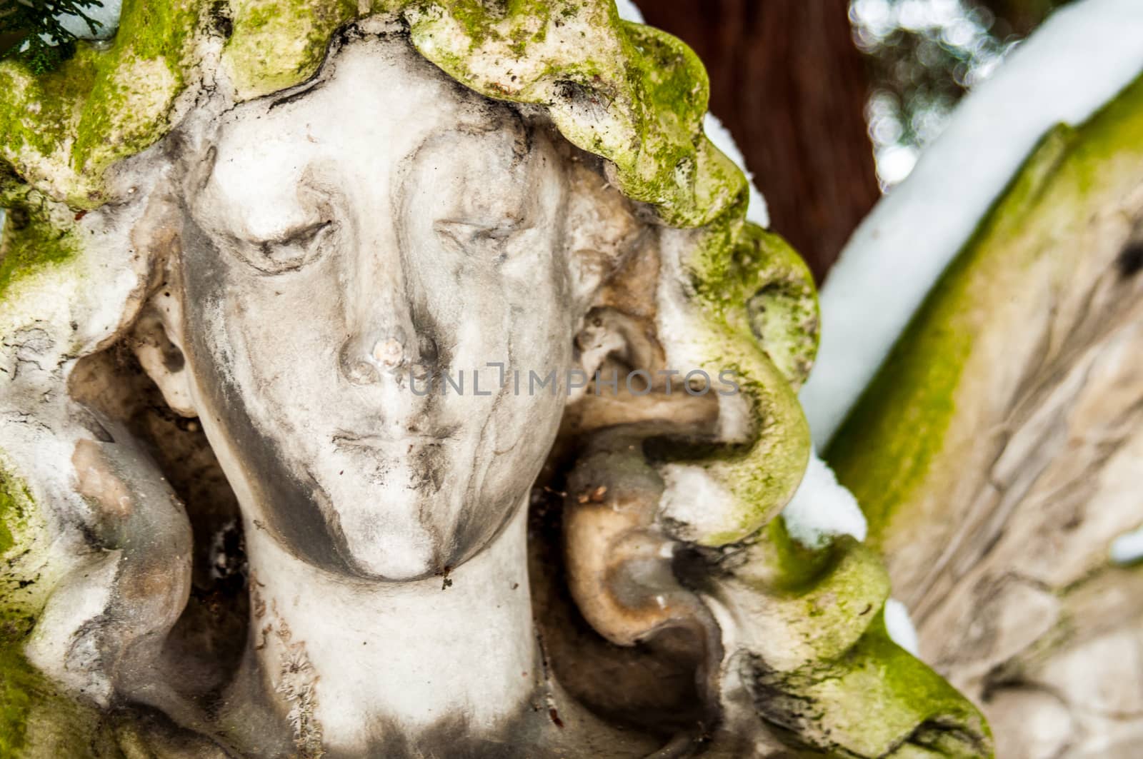 detail of a mourning sculpture on a cemetery