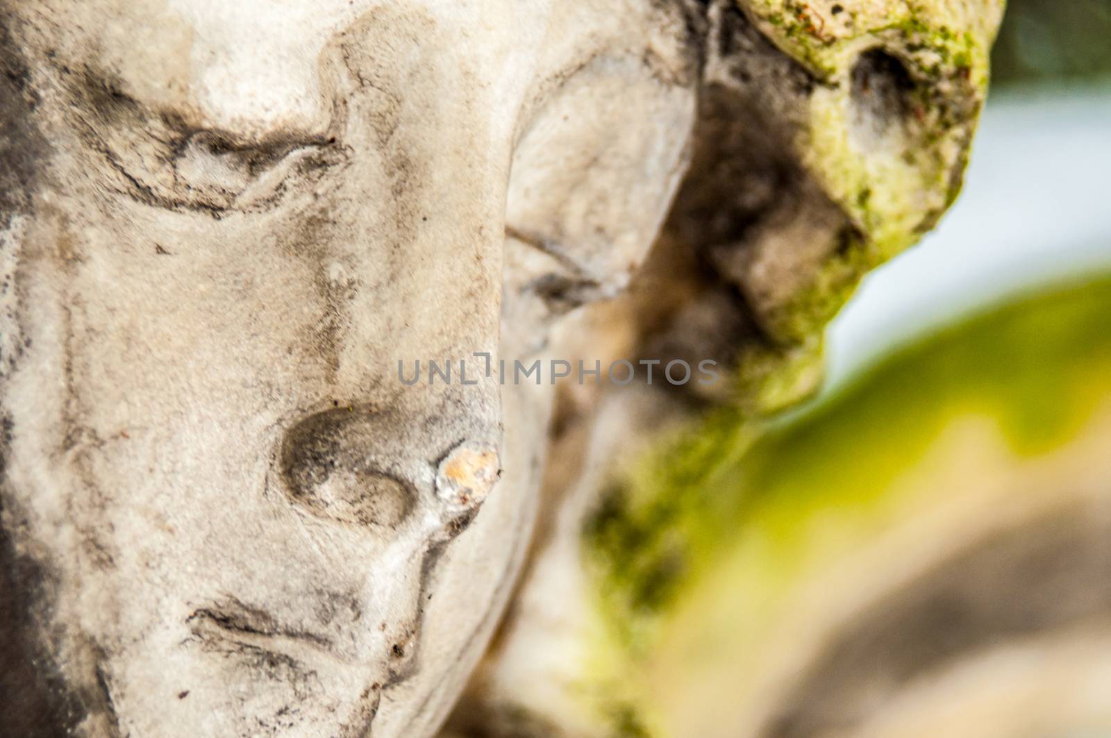 detail of a mourning sculpture on a cemetery