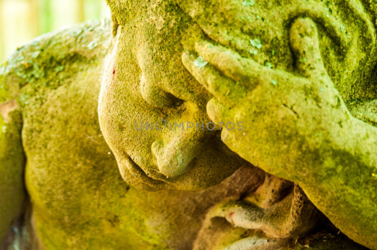 detail of a mourning sculpture on a cemetery