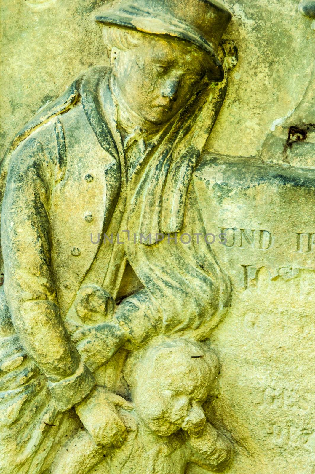 detail of a mourning sculpture on a cemetery